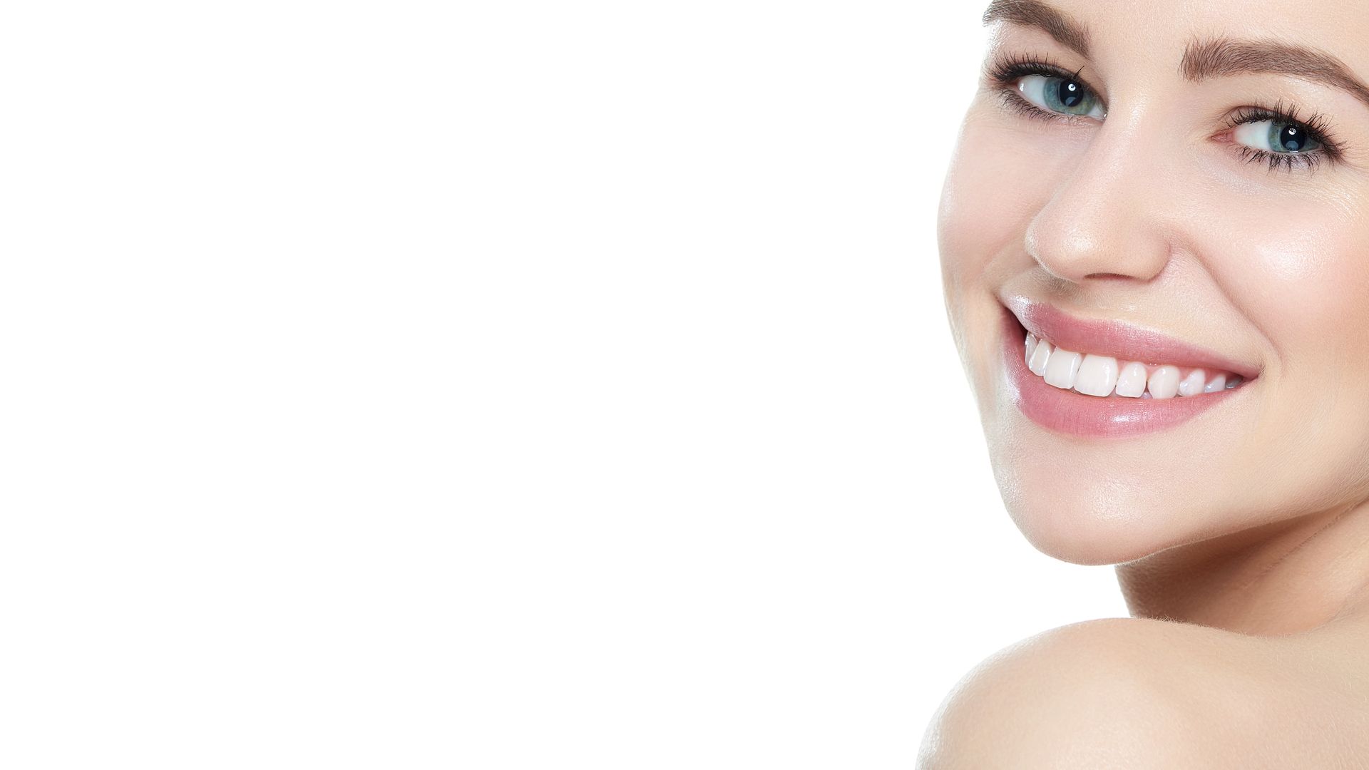 Woman with glowing skin smiling after medical spa facial aesthetics treatment, close-up view. 