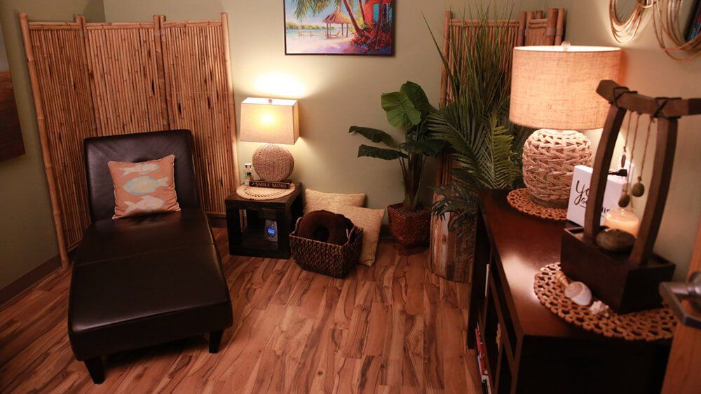 A woman is getting a head massage in a spa.
