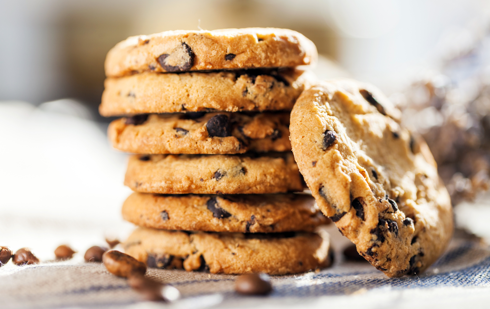 A stack of chocolate chip cookies on a table.