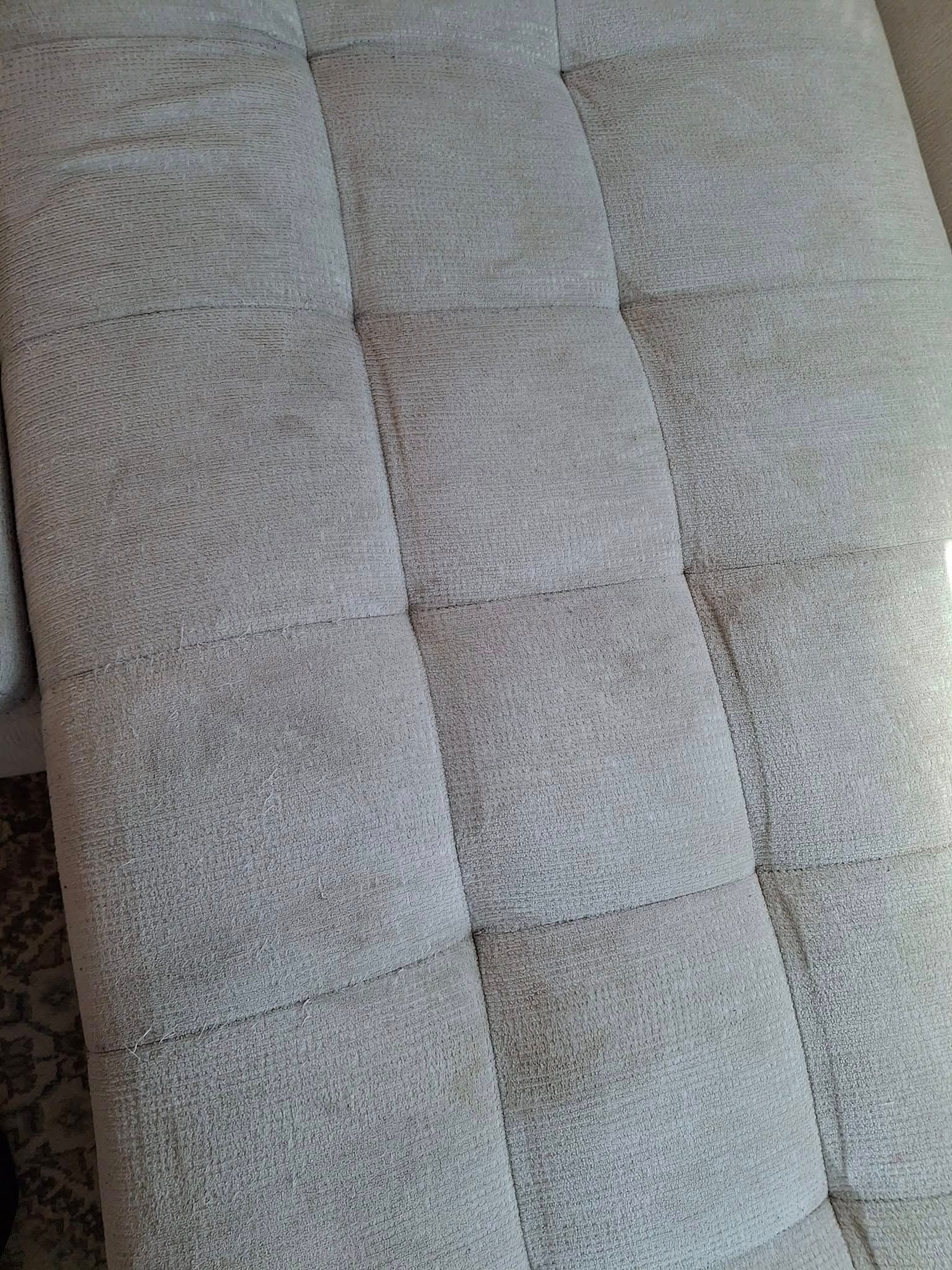 Light gray tufted sofa cushions.