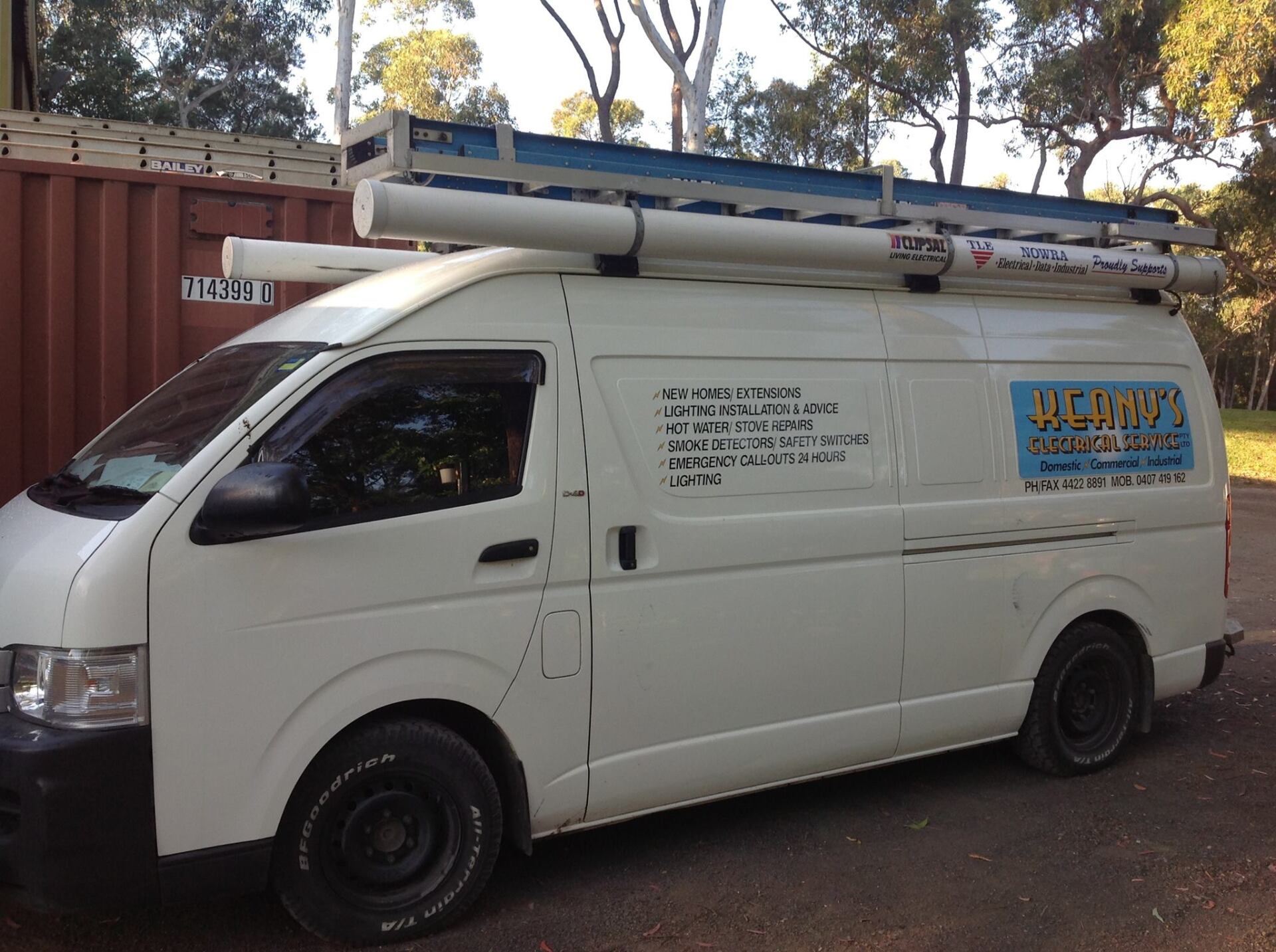 Electrician Standing Next To Van — Electrical in North Nowra, NSW