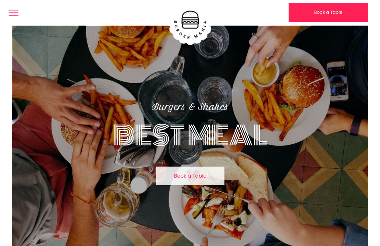 A group of people are sitting at a table with plates of food.