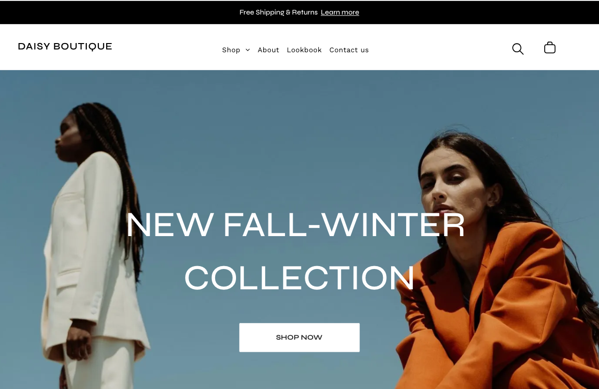 Two women are standing next to each other in front of a blue sky.