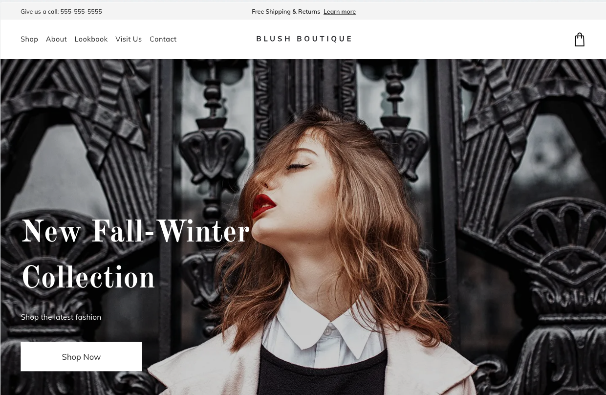 A woman is standing in front of a building with her eyes closed.