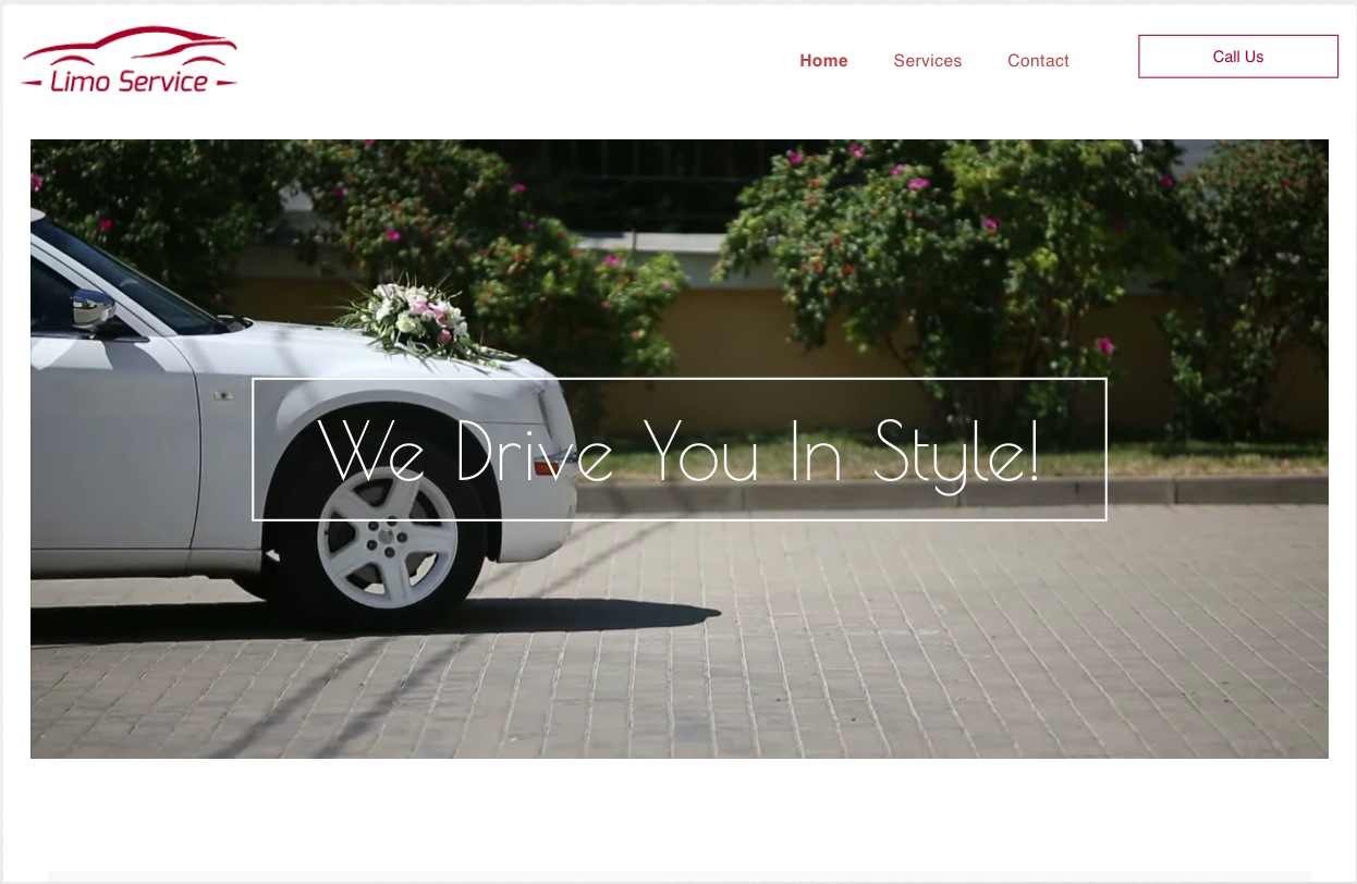 A white car with flowers on it is parked on a brick driveway.