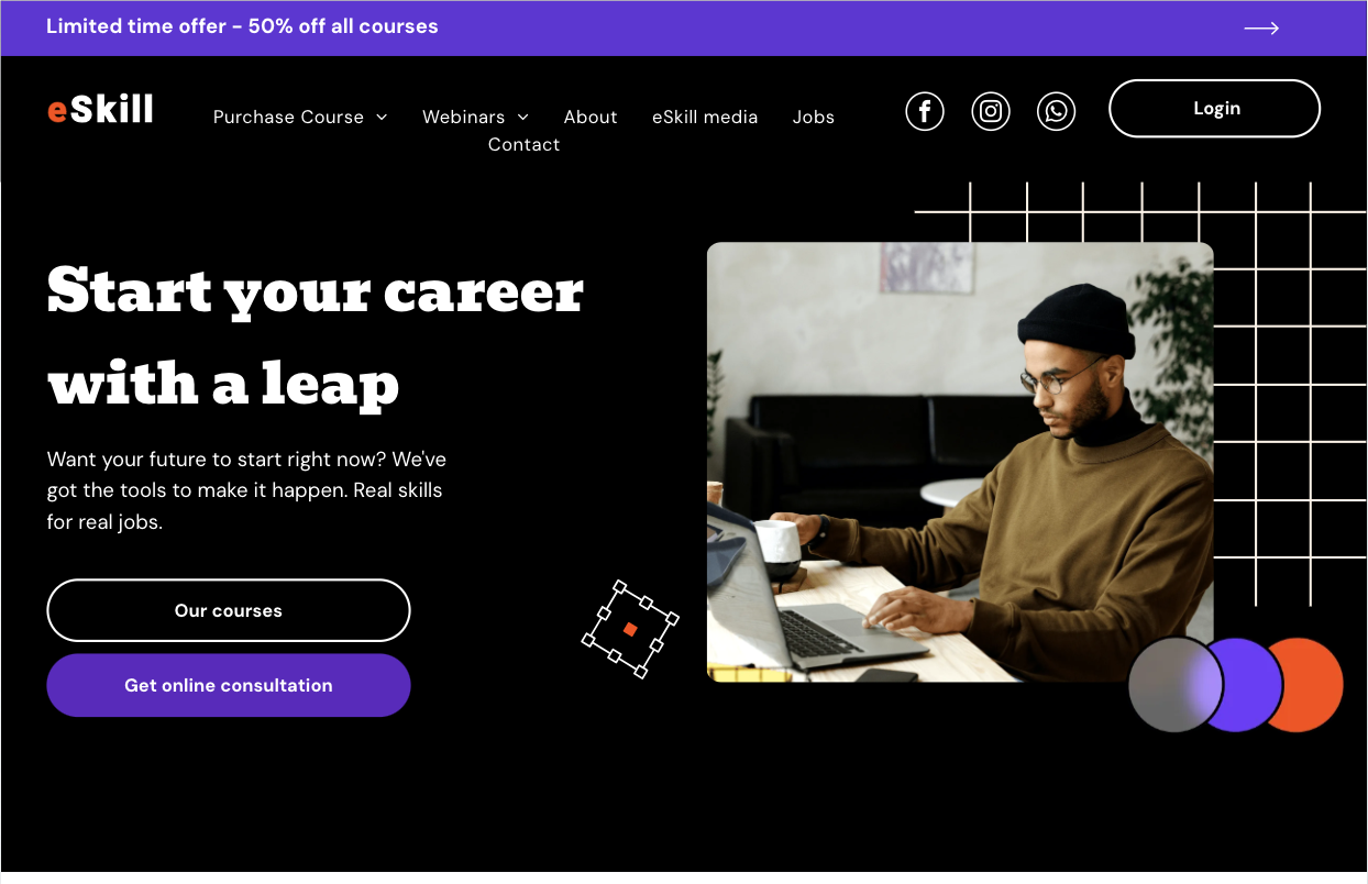 A man is sitting at a desk using a laptop computer.