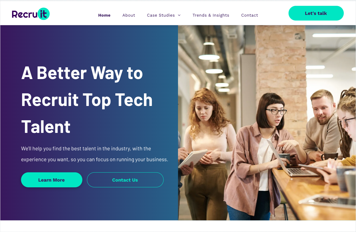 A group of people are standing around a table looking at a tablet.