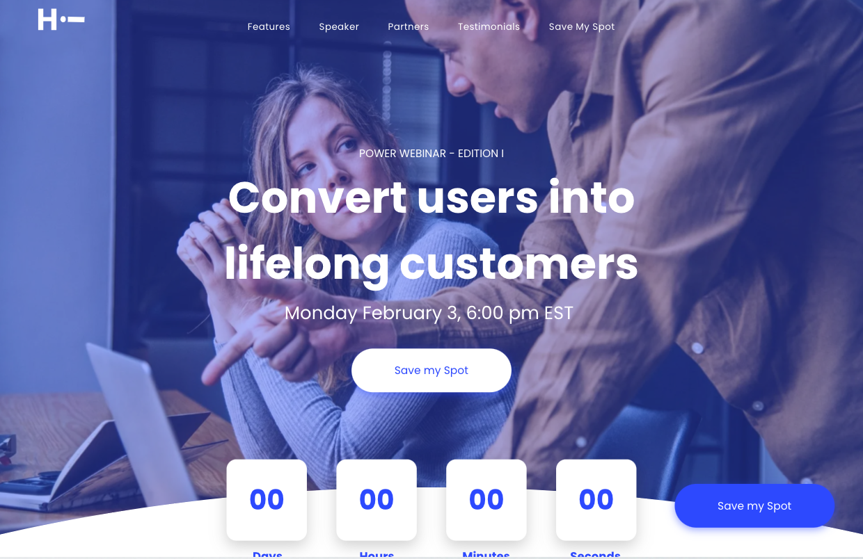 A man and a woman are looking at a laptop computer.