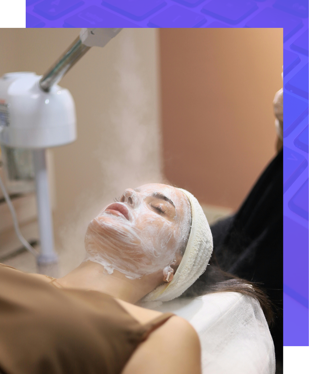 Four people laughing and looking at their phones outdoors.