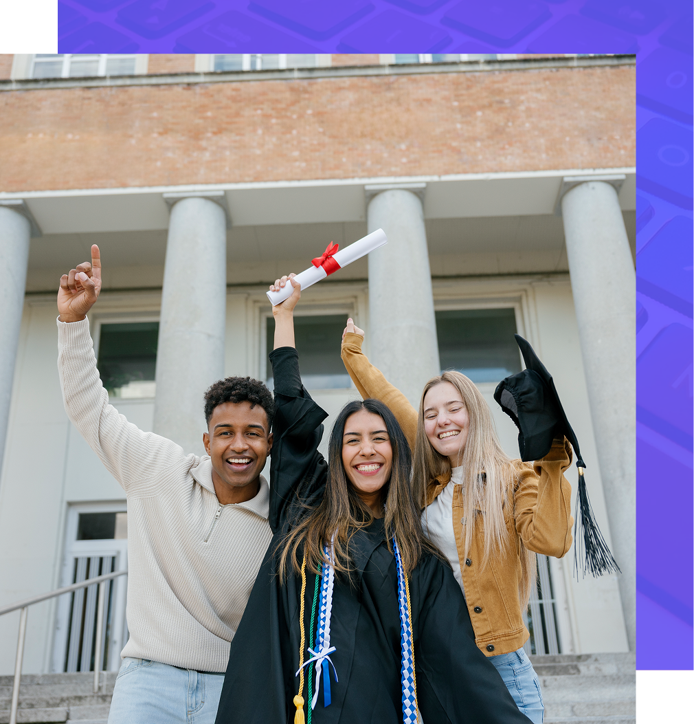Three students celebrate graduation in front of a brick building with white columns, one holding a diploma and a cap.