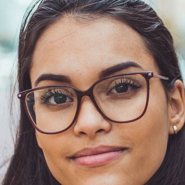 A close up of a woman 's face wearing glasses