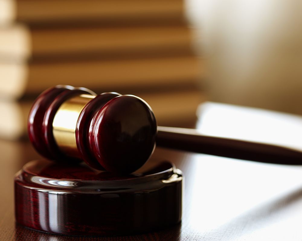 Close-up of a judge's gavel on a wooden block, illustrating the essence of law. Workers' Compensatio