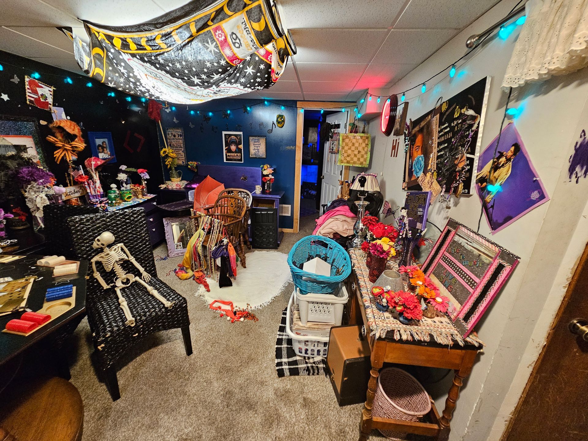 A messy room with a skeleton on the floor