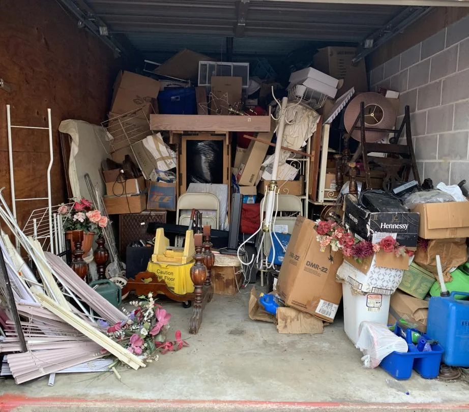a garage filled with lots of junk and boxes .