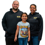 A man and woman standing next to a little girl wearing a viking shirt