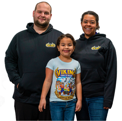 A man and woman family standing next to a little girl wearing a Viking junk removal shirt.