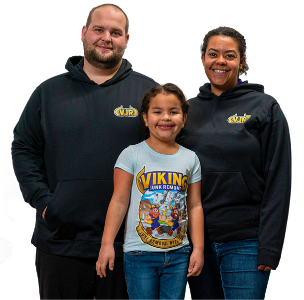 A man and woman standing next to a little girl wearing a viking shirt