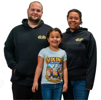 A man and woman standing next to a little girl wearing a viking shirt