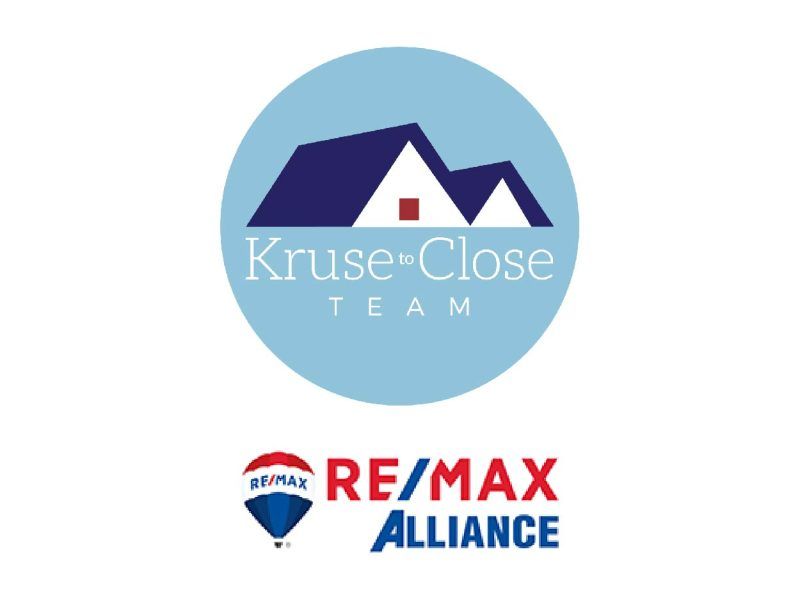 Logo for the Kruse to Close Team at RE/MAX Alliance featuring a blue circle with a stylized roof icon.