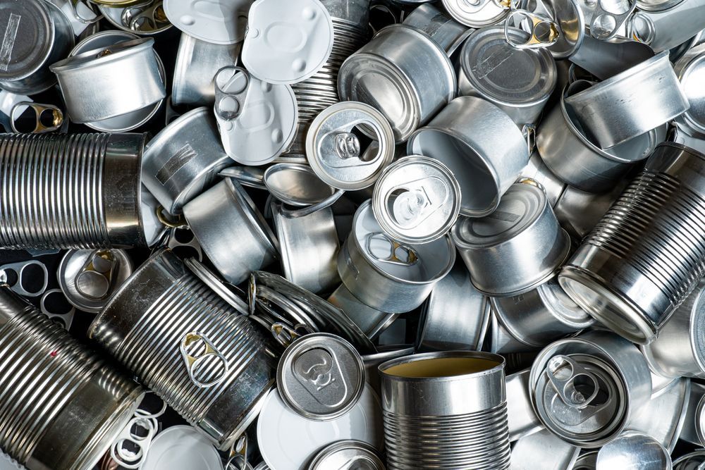 A pile of crushed aluminum cans on a table.