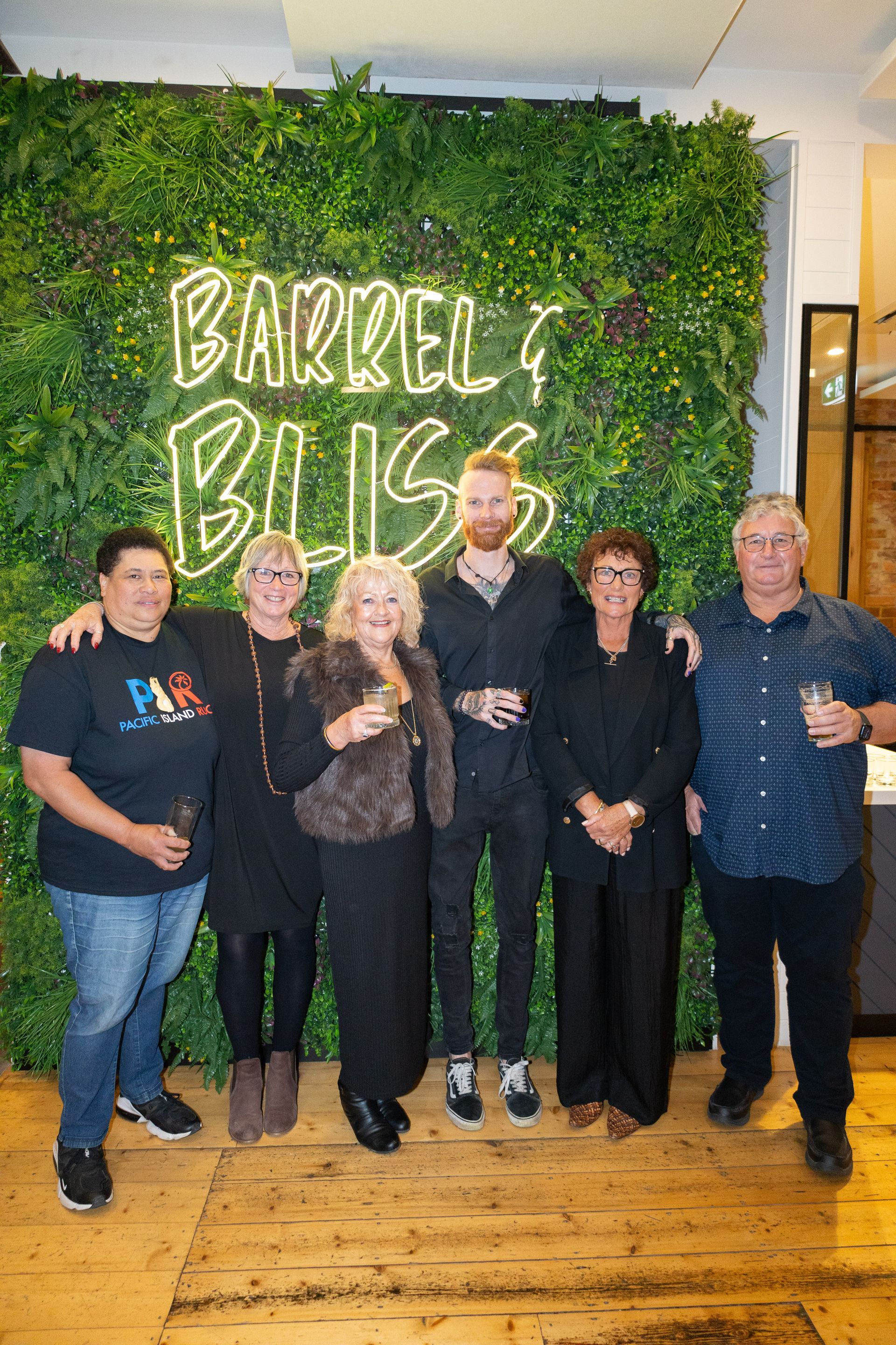 Group of people pose in front of a 