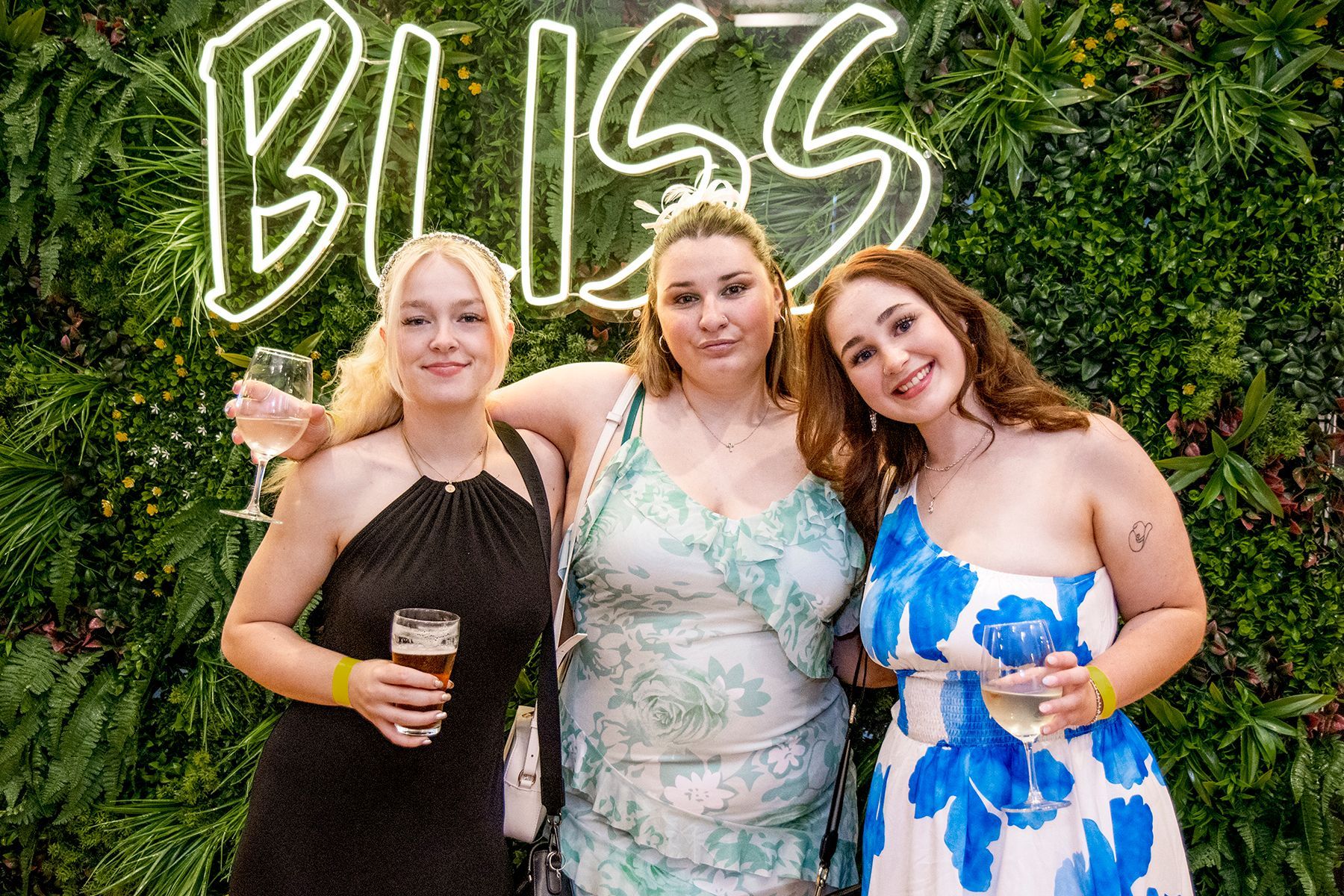 Three women smiling at a 