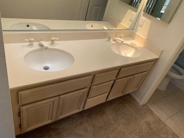 a bathroom with two sinks and a mirror .