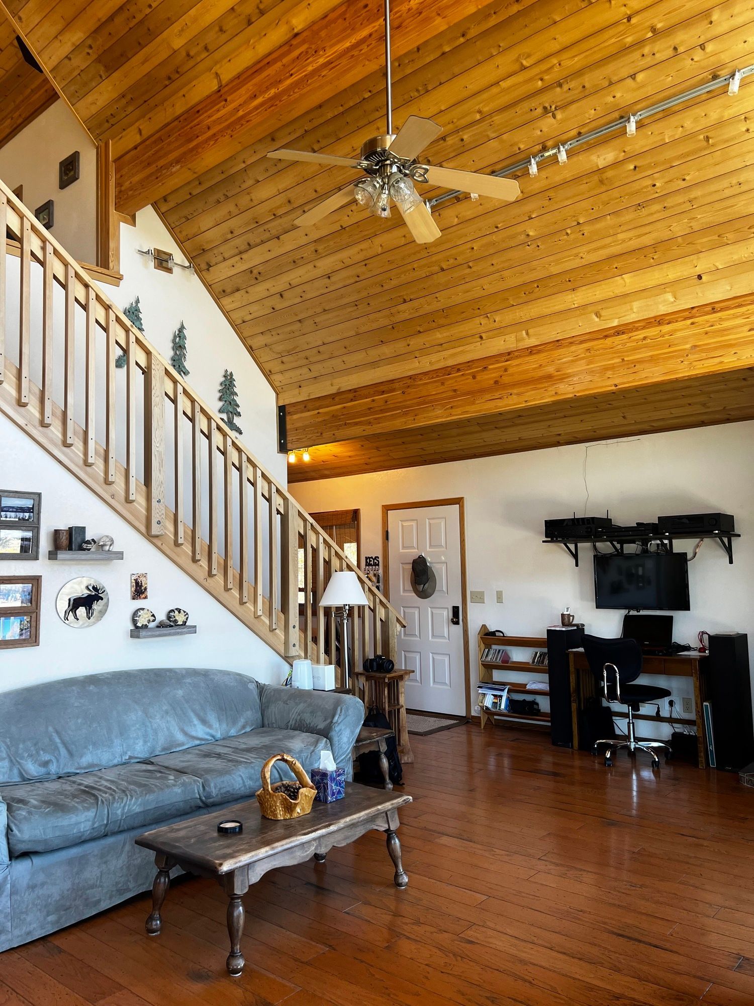 a living room with a couch and a ceiling fan