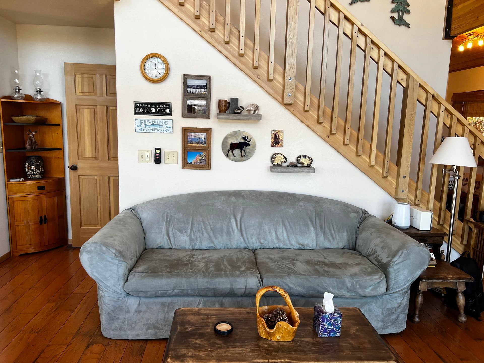 a living room with a couch and stairs in the background
