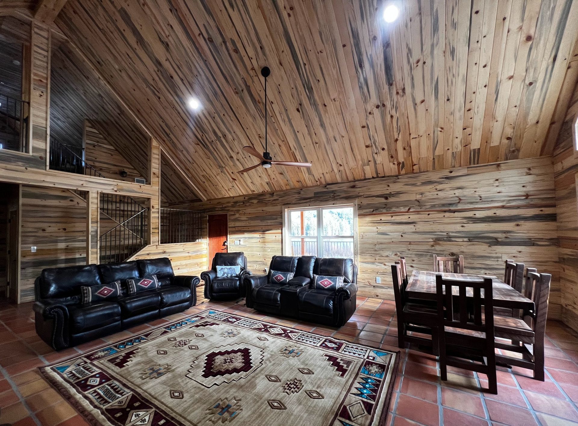 a living room filled with furniture and a rug in a log cabin .