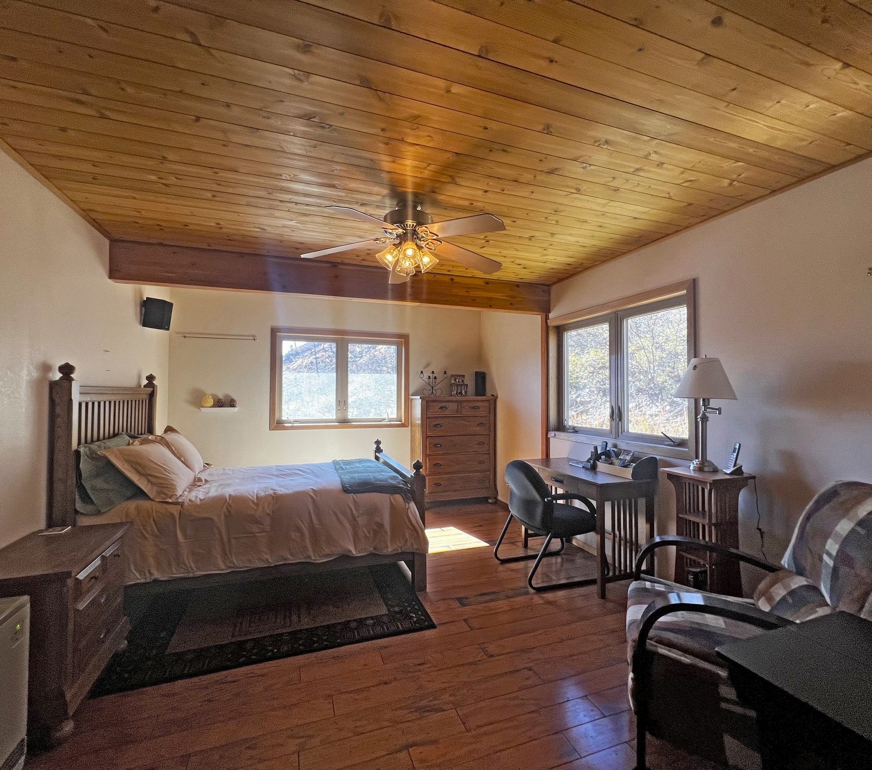 a bedroom with a ceiling fan and a bed