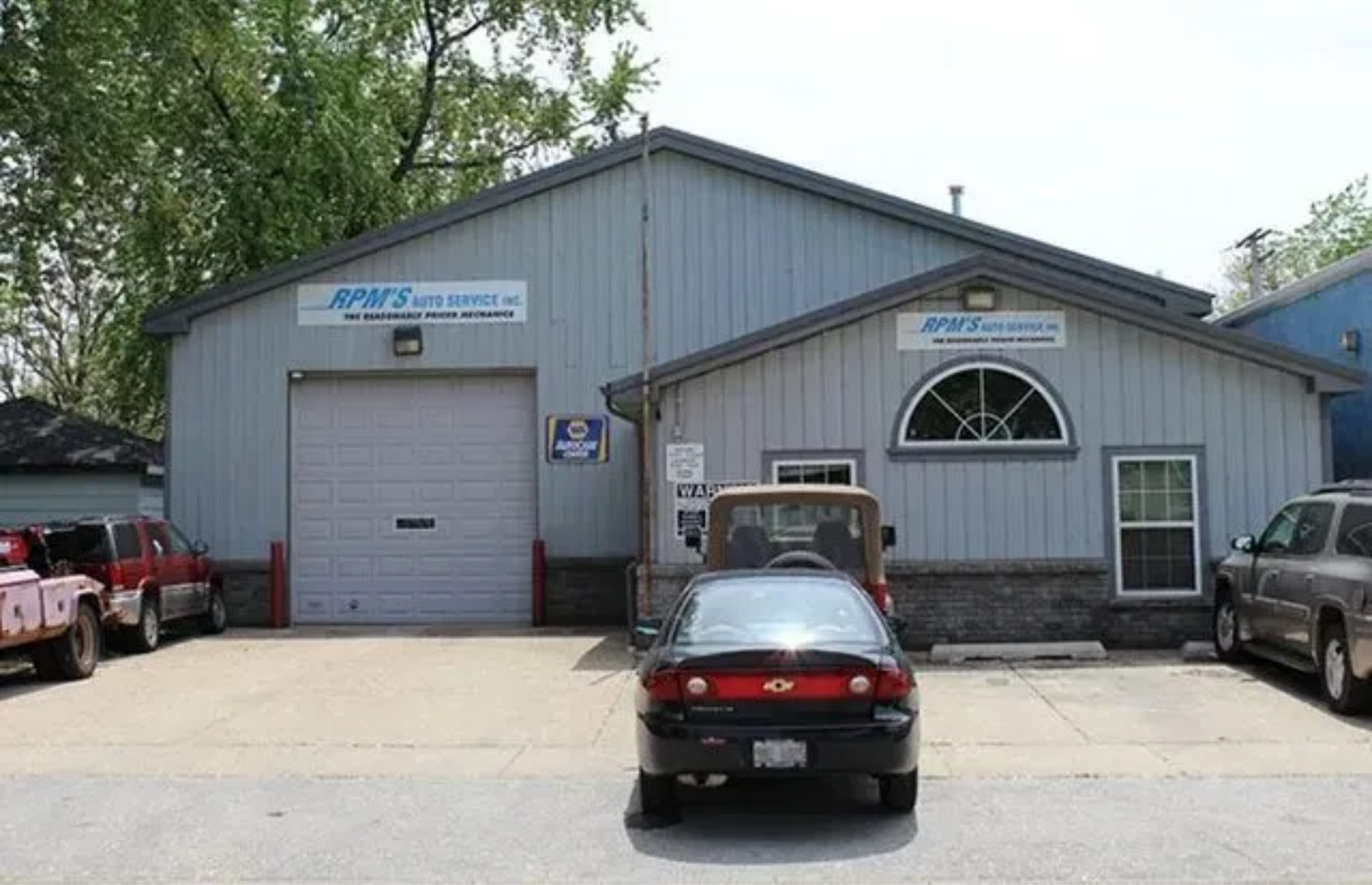 A garage with a car parked in front of it