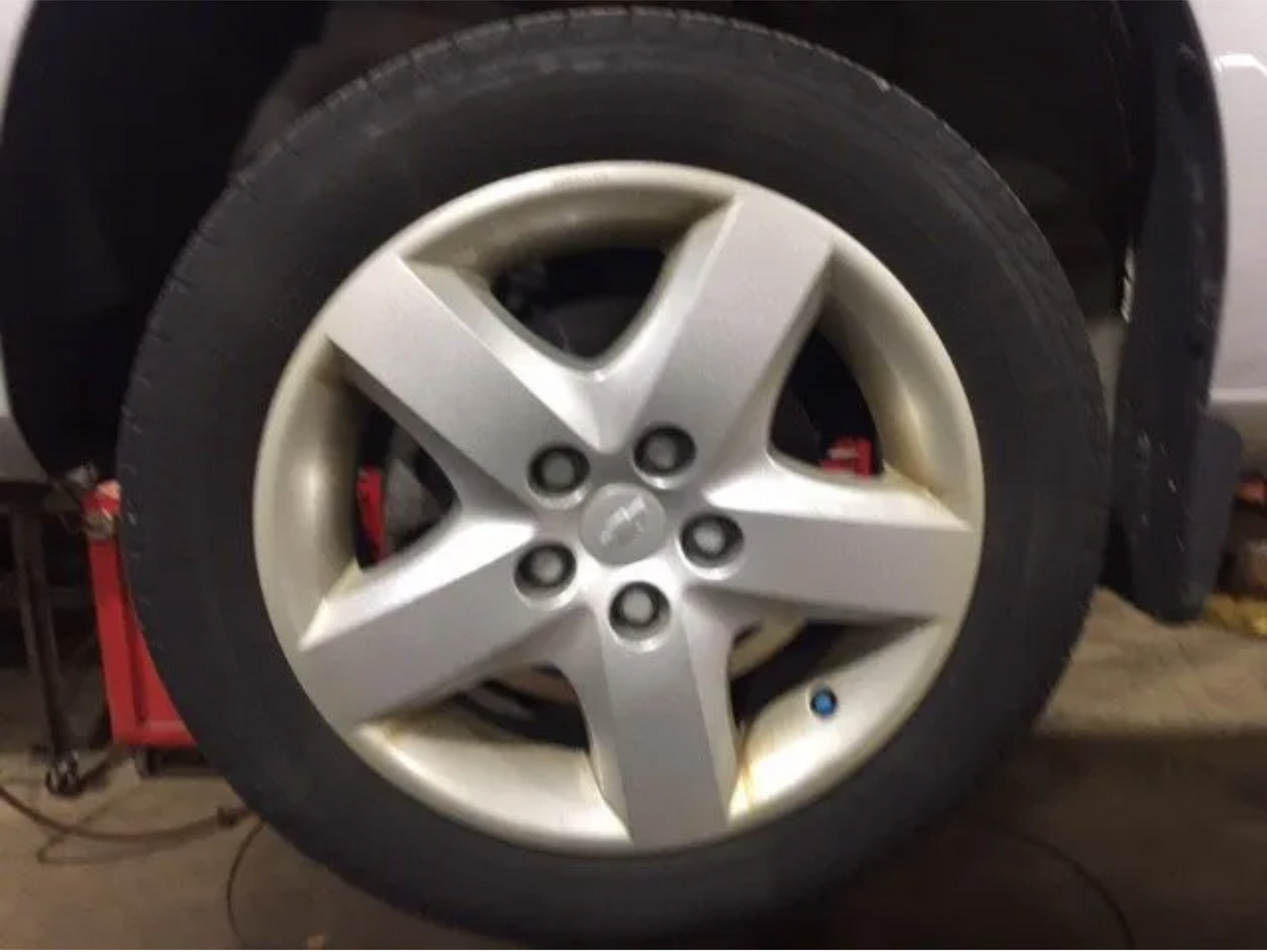 A close up of a silver wheel on a car