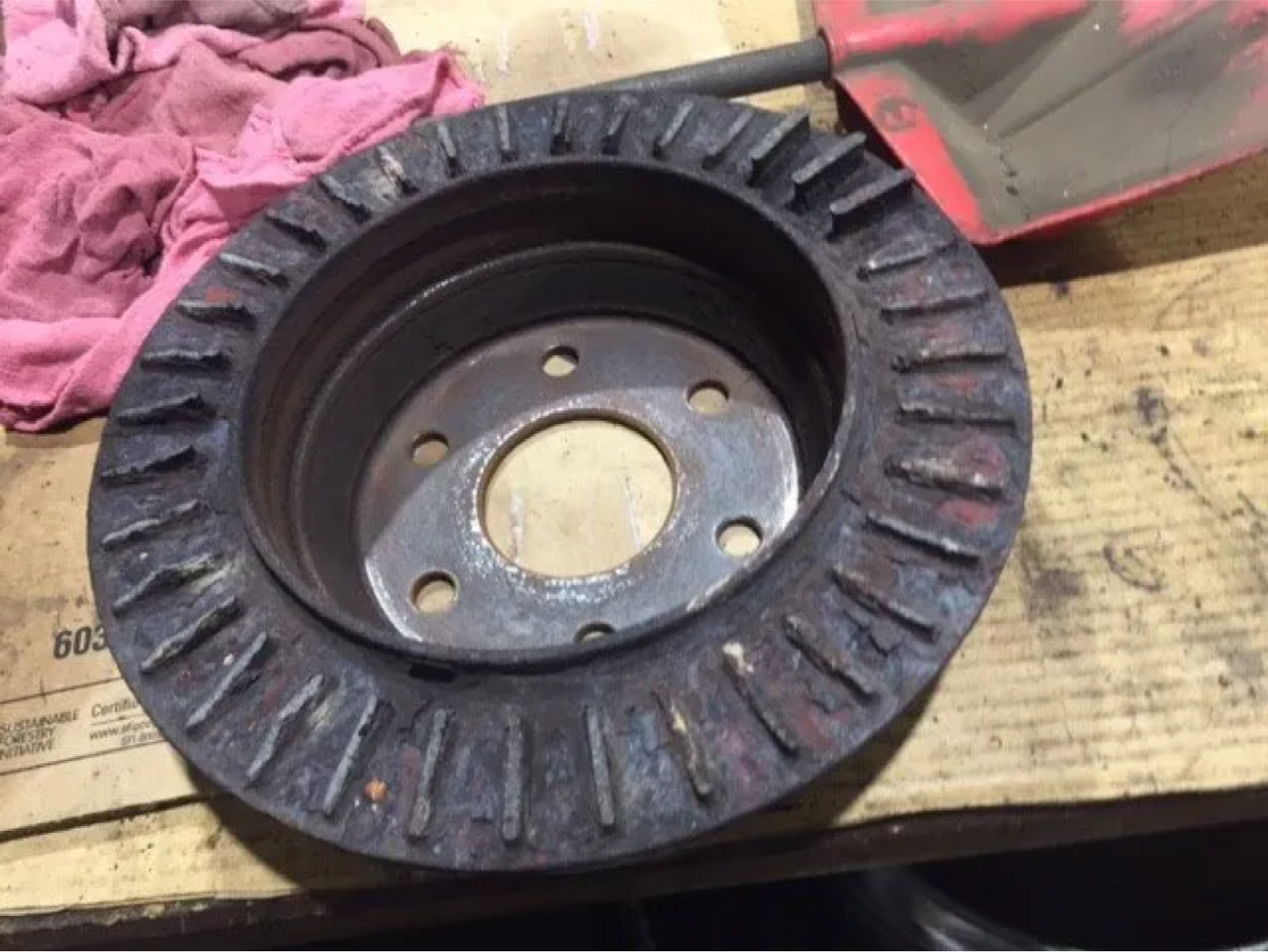 A close up of a brake disc on a wooden table