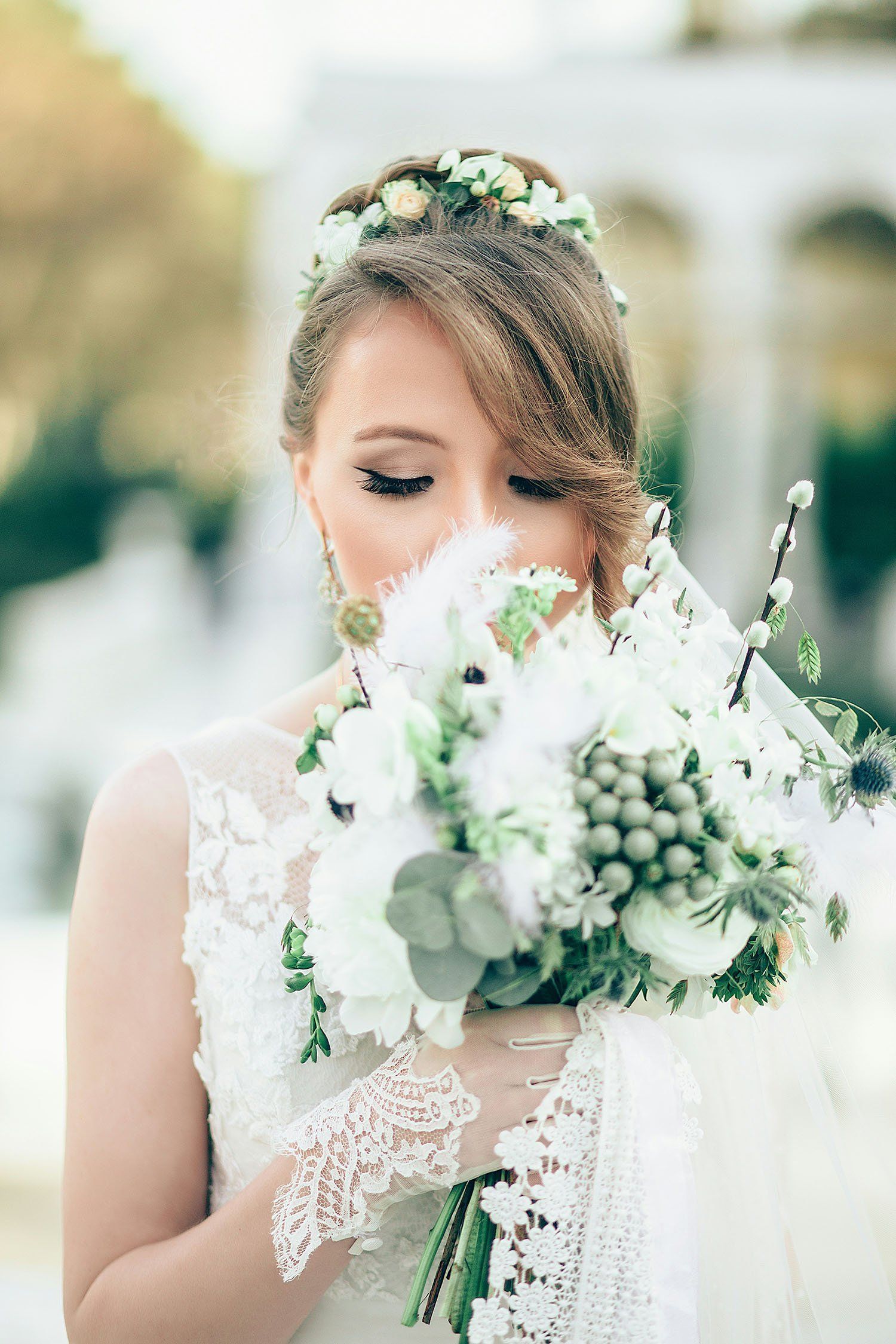 A Bride enjoys her wedding bouquet outside.