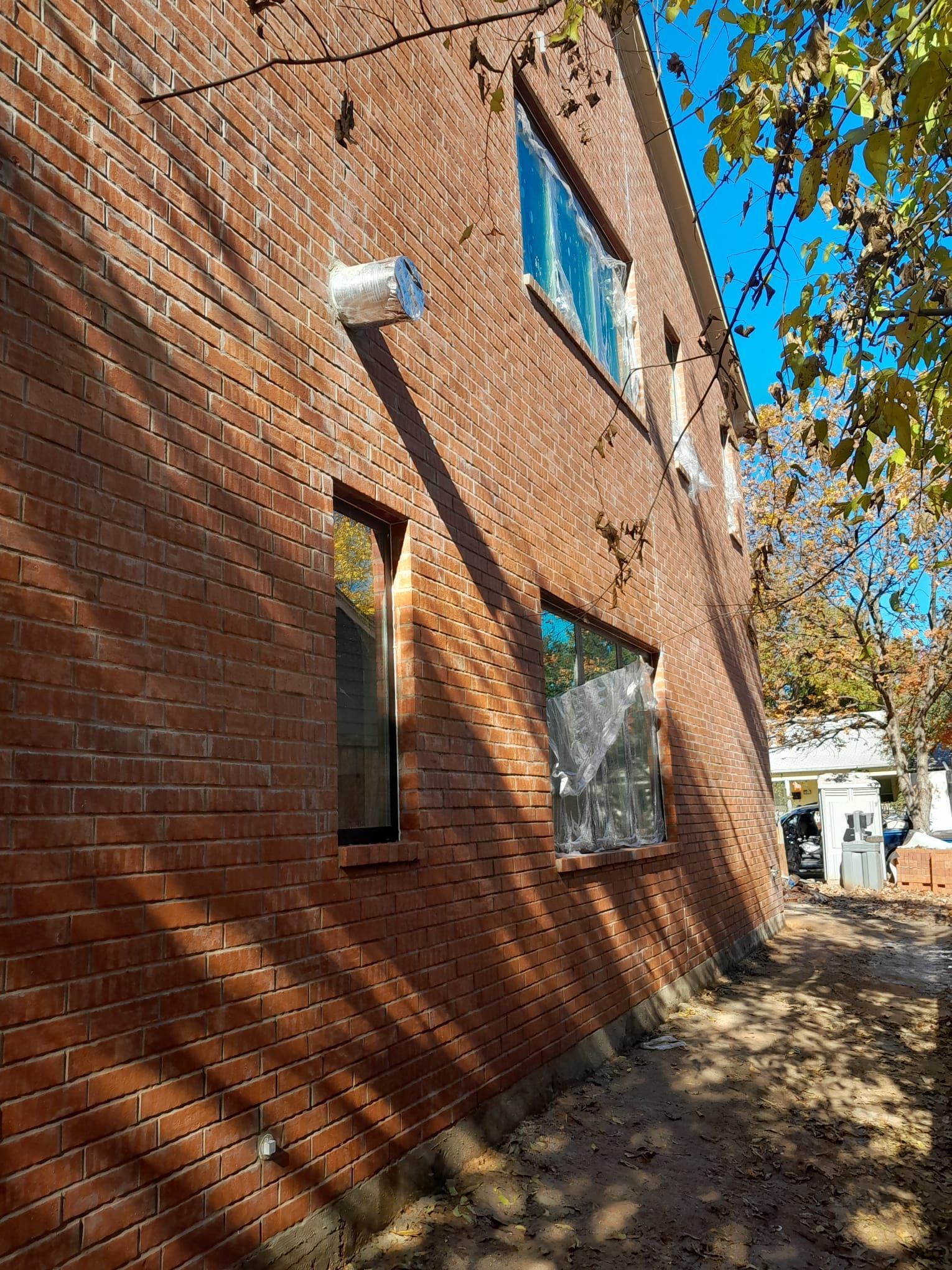 A brick building with a lot of windows on the side of it.