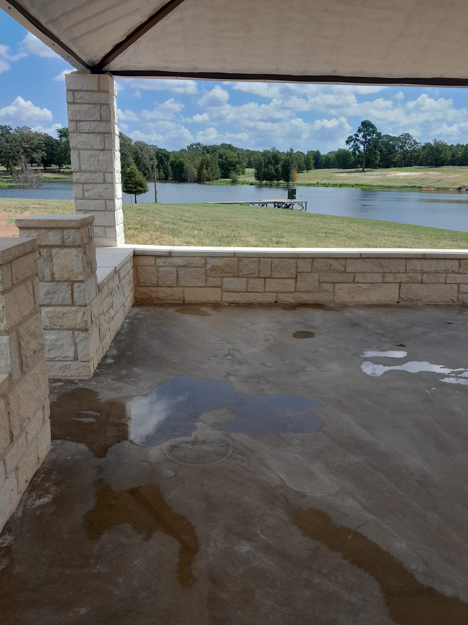 A patio with a view of a lake and trees