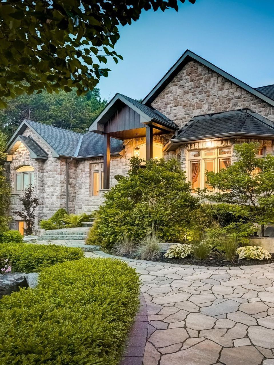 A large stone house with a stone walkway leading to it