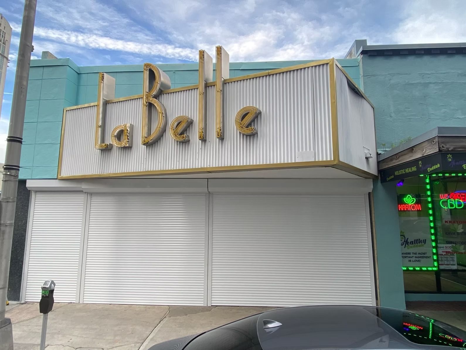A bedroom with a bed and shutters on the windows