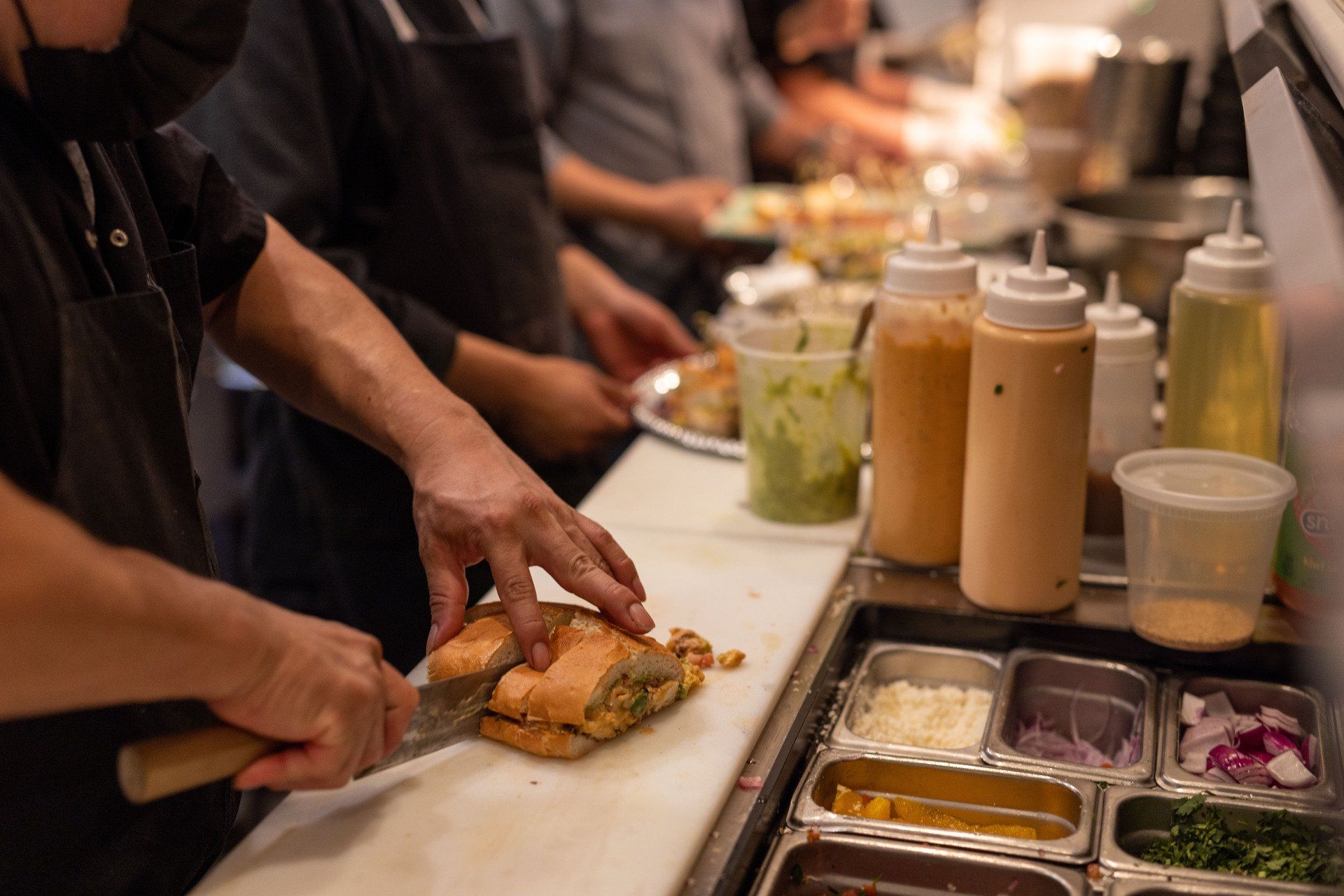 chef cutting a sandwich