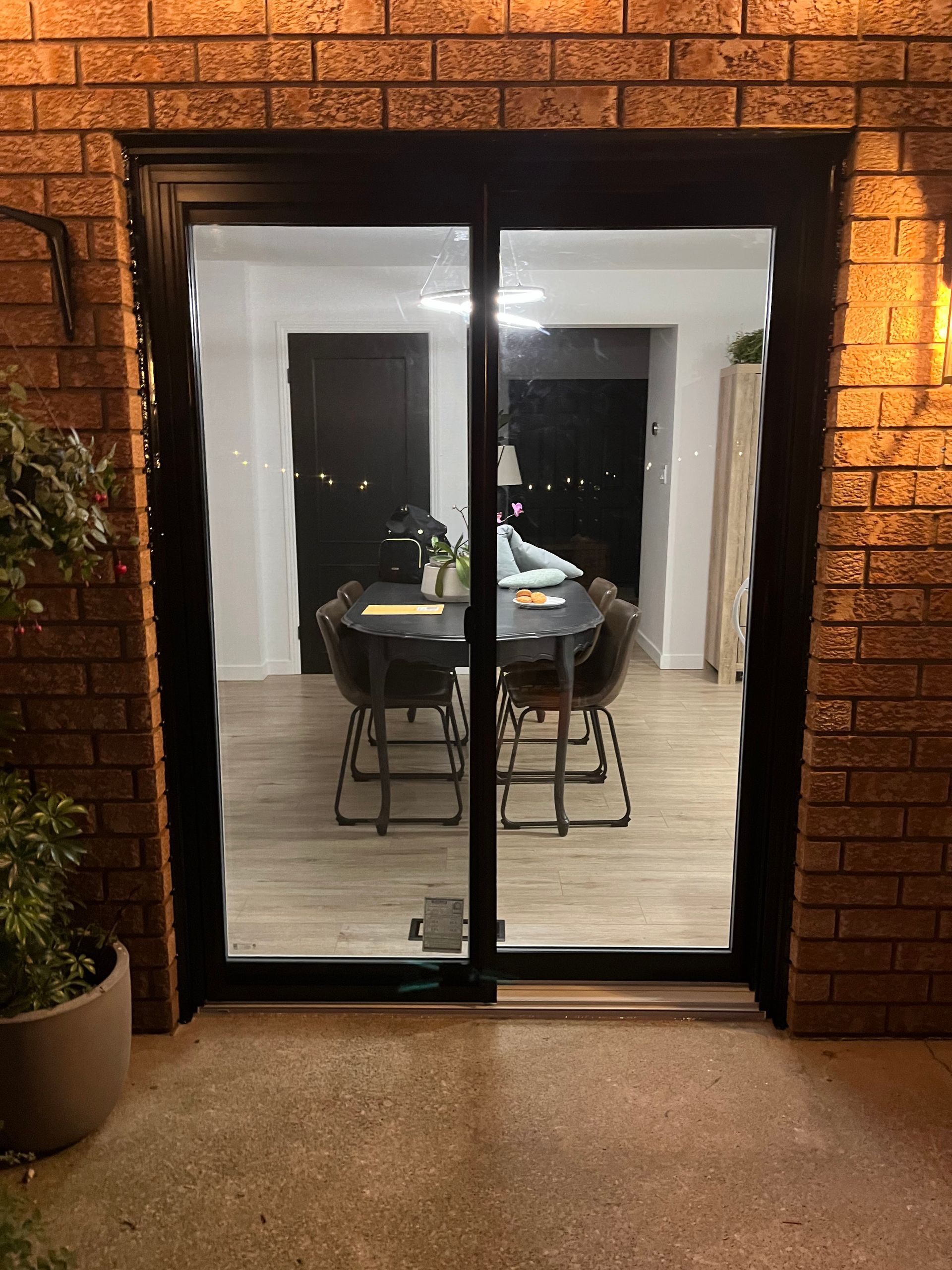 A white sliding glass door with a handle on a white background.