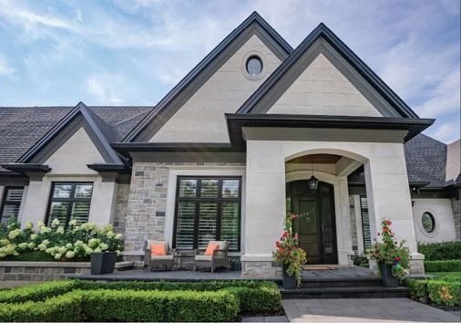 A large window on the side of a brick house.