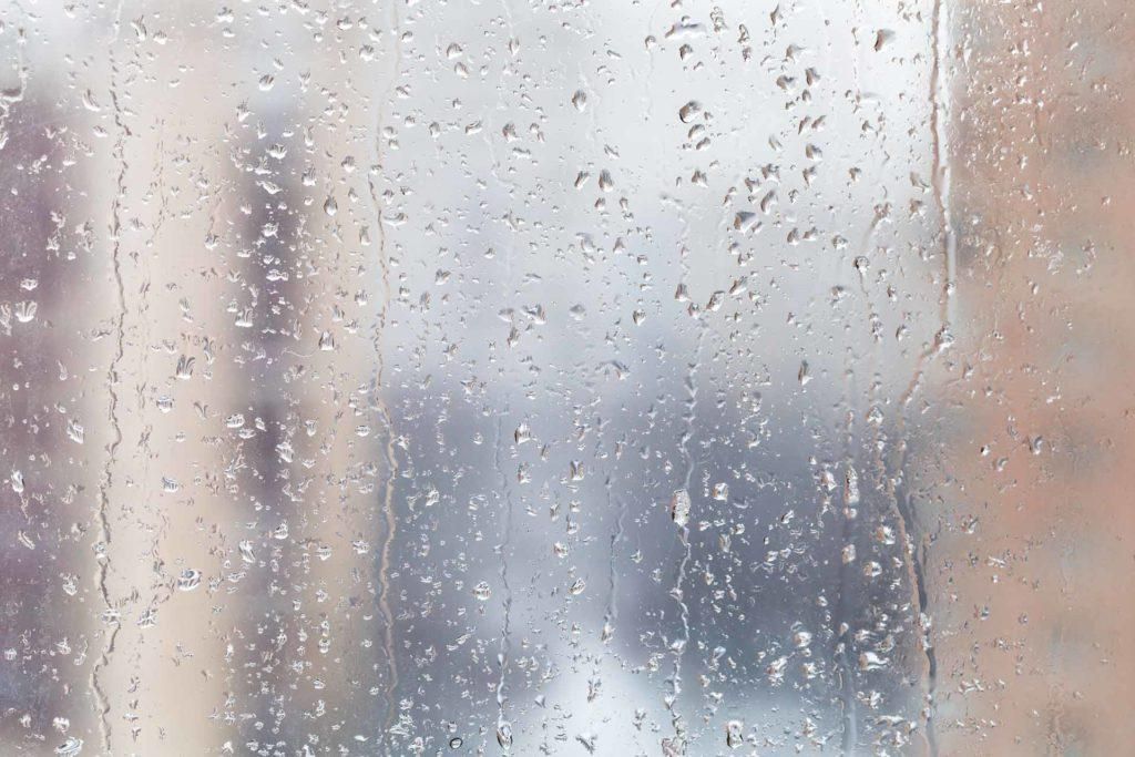 A close up of rain drops on a window.