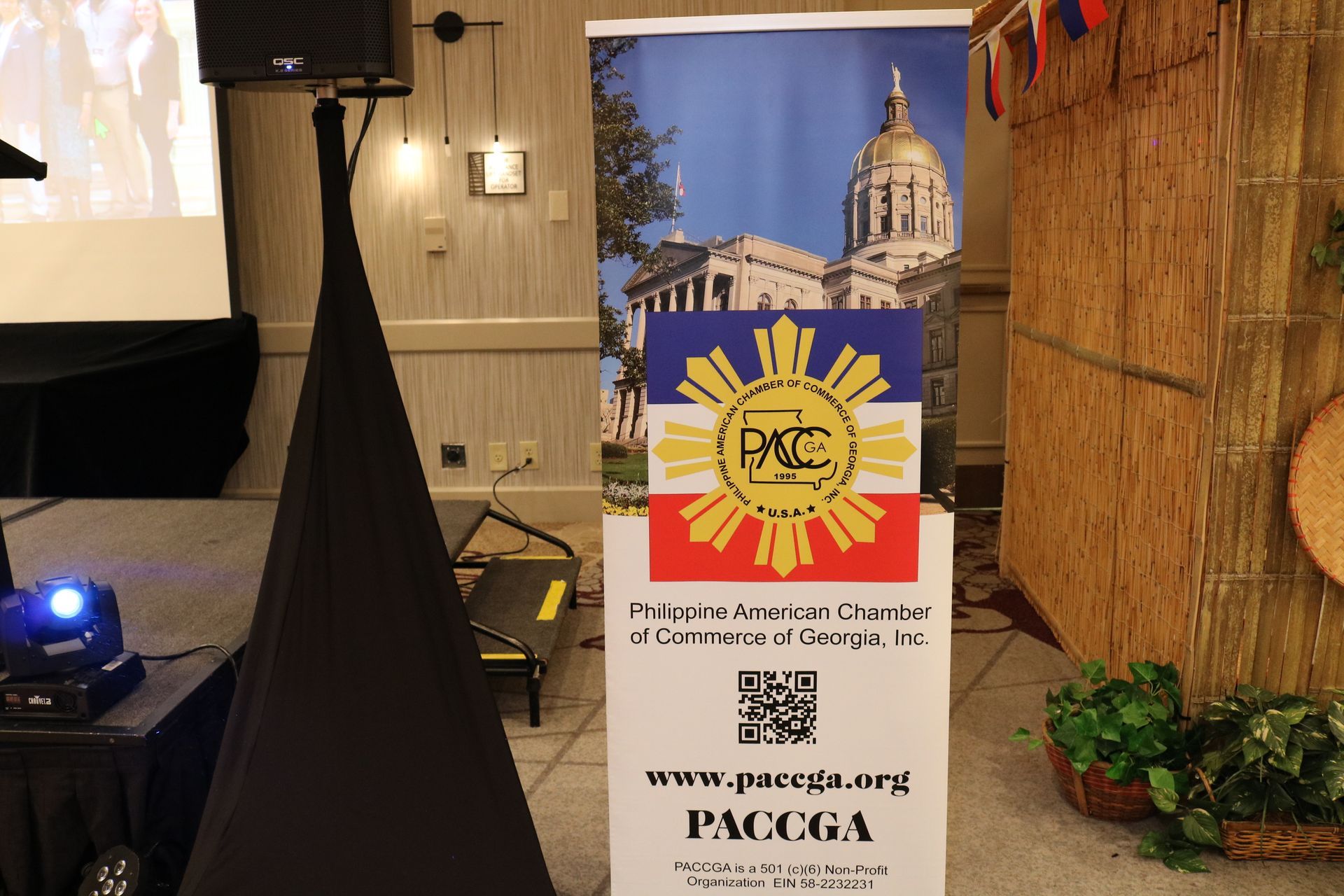 Banner for Philippine American Chamber of Commerce of Georgia featuring logo and website in event setting.