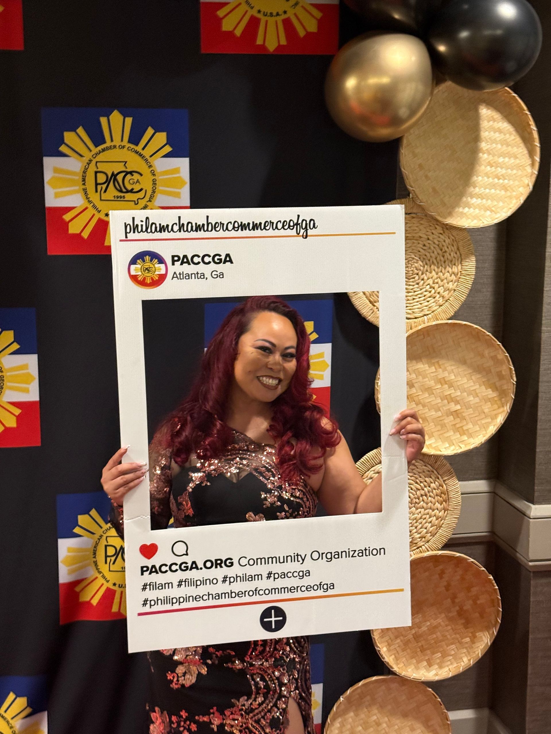 Woman poses with a social media frame, event backdrop with Philippine flag.