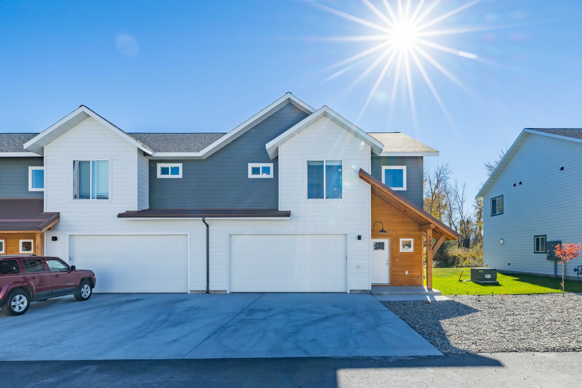 A house with a red truck parked in front of it