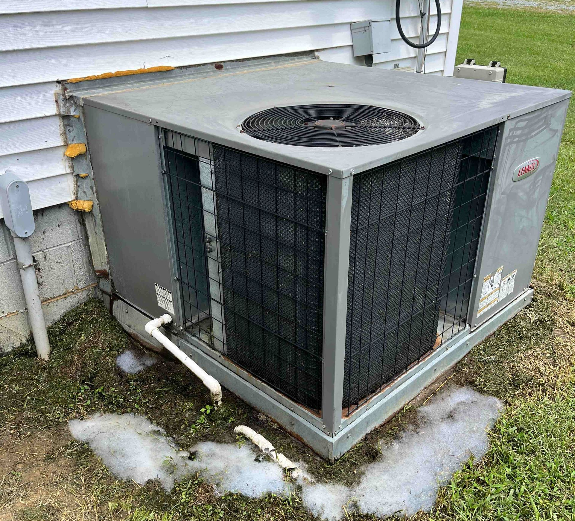 HVAC technician repairing an air conditioner, giving a thumbs-up. HVAC technician repairing an air conditioner, giving a thumbs-up.