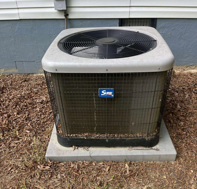 Man repairs air conditioning unit outdoors, crouching, tools visible. Man repairs air conditioning unit outdoors, crouching, tools visible.