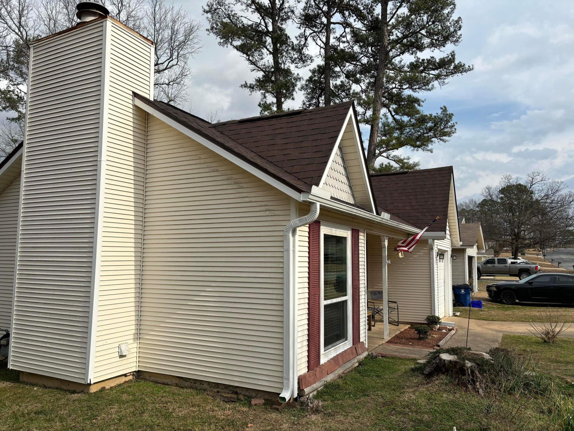 A small house with a chimney on the side of it.