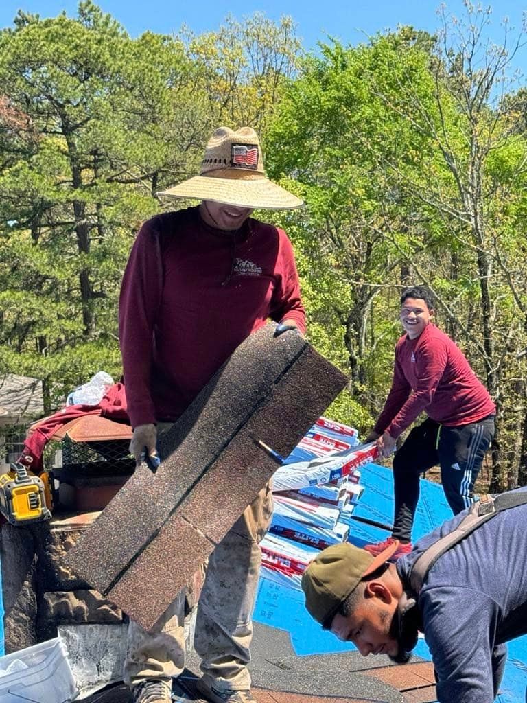 A group of men are working on a roof.